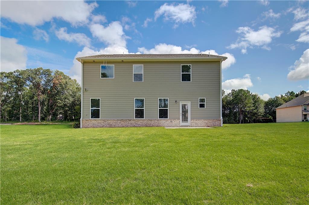 419993 St Anne's Place Covington, GA 30016 - Photo 28 of 30 a view of a house with a backyard