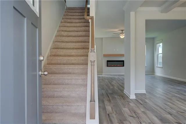 a view of a hallway with wooden floor and entryway