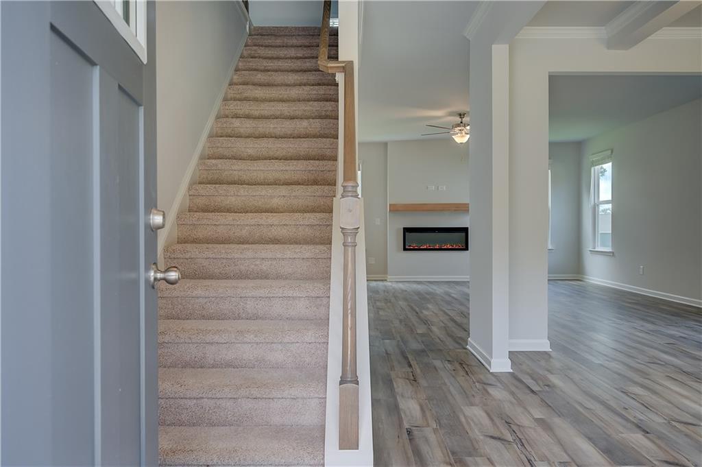 419993 St Anne's Place Covington, GA 30016 - Photo 4 of 30 a view of a hallway with wooden floor and entryway