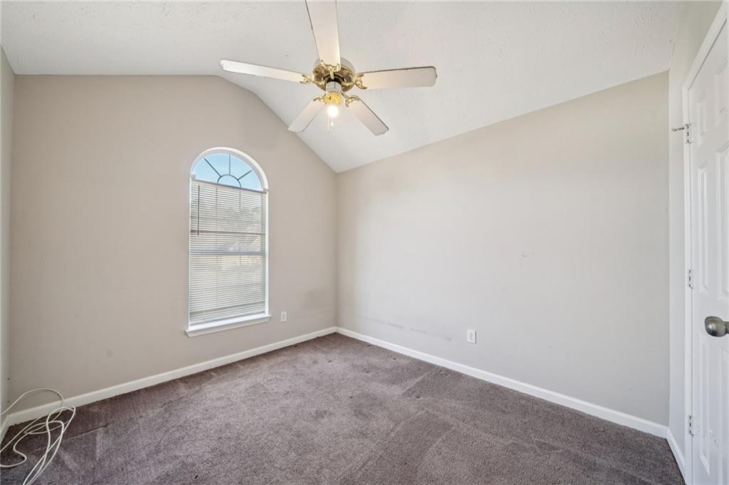 1443 Pebble Ridge Lane Hampton, GA 30228 - Photo 19 of 24 an empty room with windows and fan