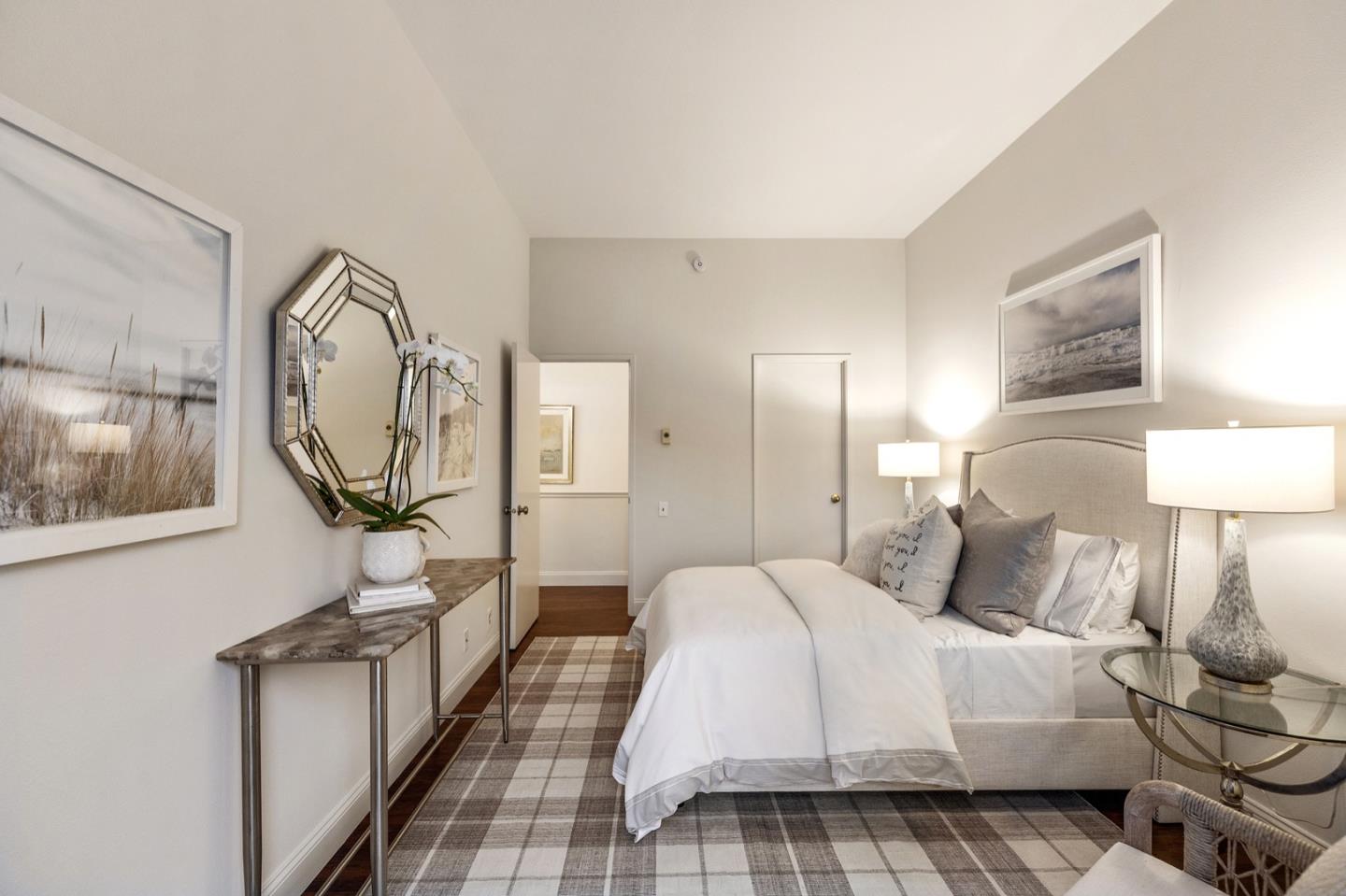 2345 Armada Way San Mateo, CA 94404 - Photo 19 of 32 a bedroom with a bed a mirror and lamp