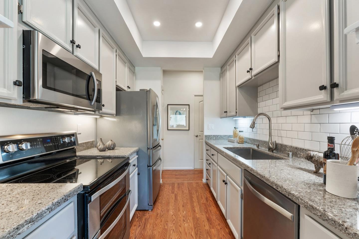 2345 Armada Way San Mateo, CA 94404 - Photo 10 of 32 a kitchen with stainless steel appliances granite countertop a sink a stove and a microwave