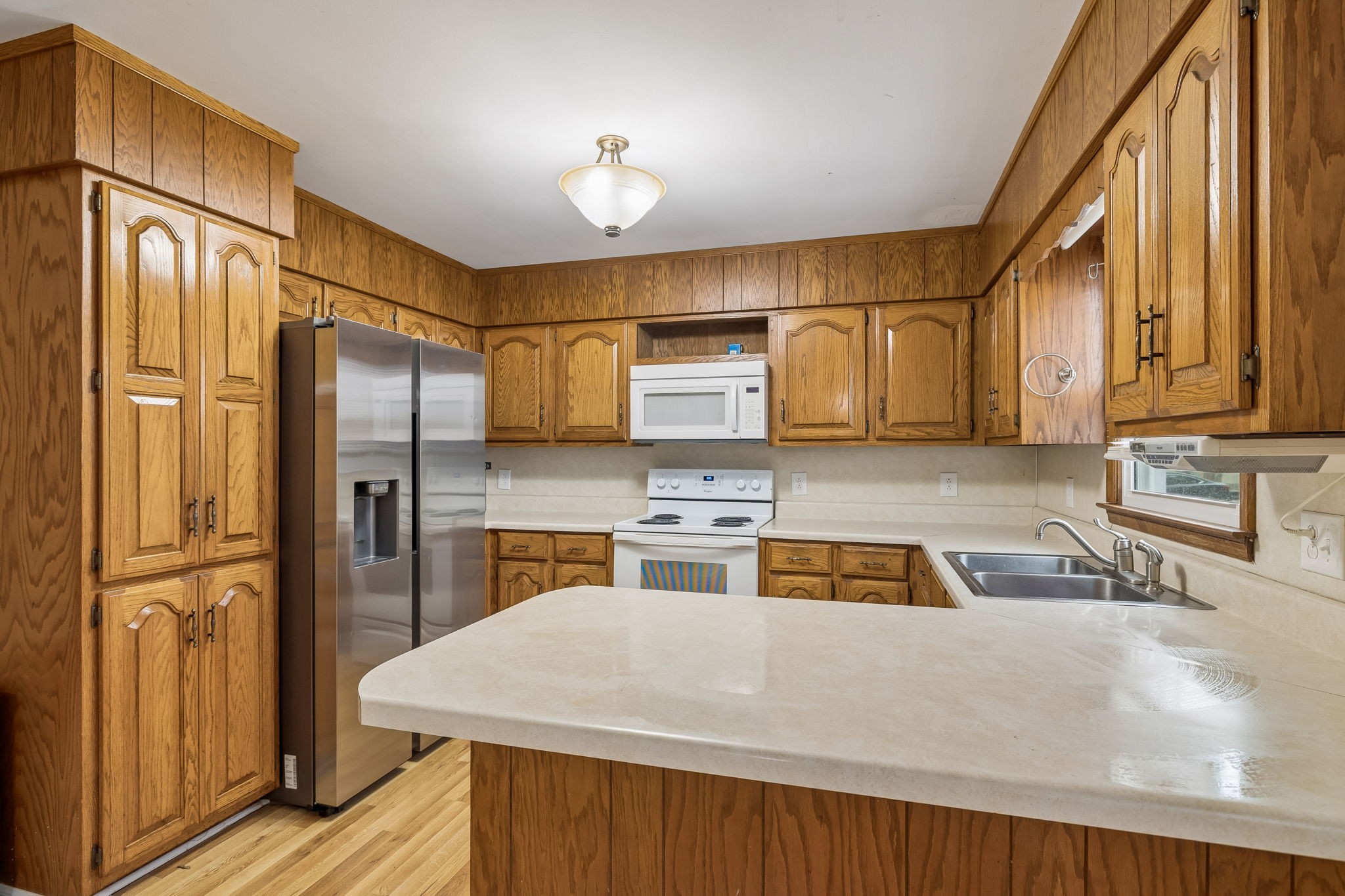 3669 Bluff Springs Road McMinnville, TN 37110 - Photo 16 of 51 a kitchen with a refrigerator a stove and a cabinets with wooden floor