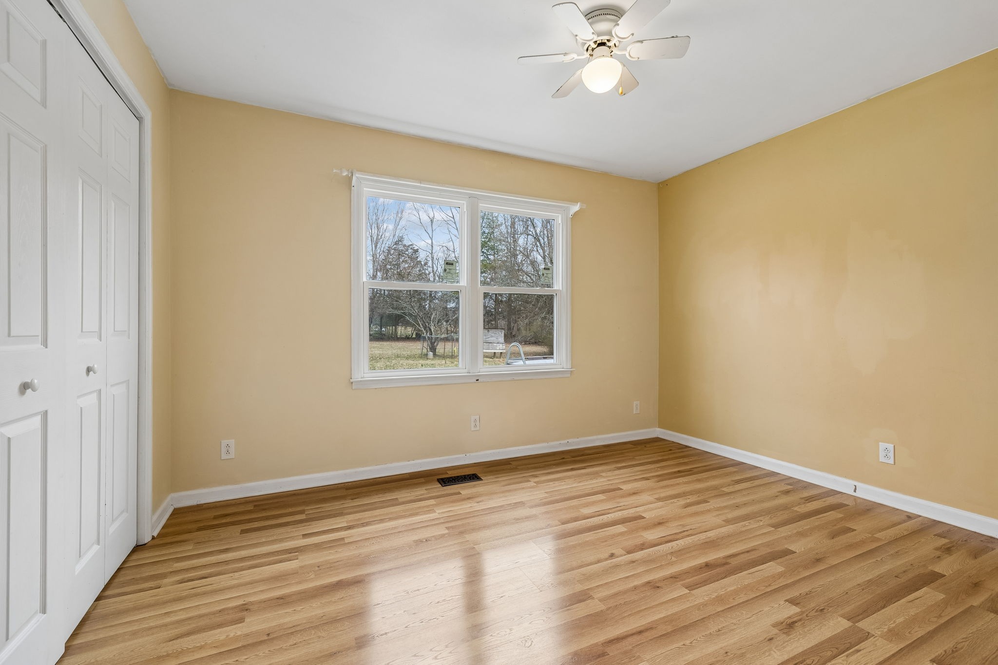 3669 Bluff Springs Road McMinnville, TN 37110 - Photo 24 of 51 a view of an empty room with wooden floor and a window