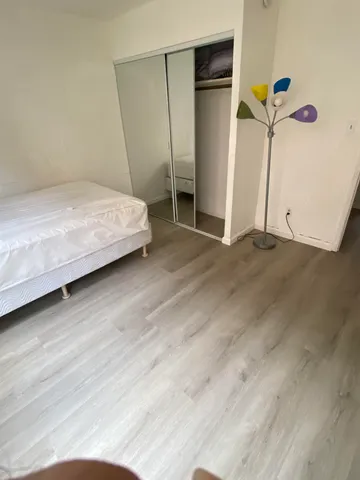 a bedroom with a bed and a walk in closet