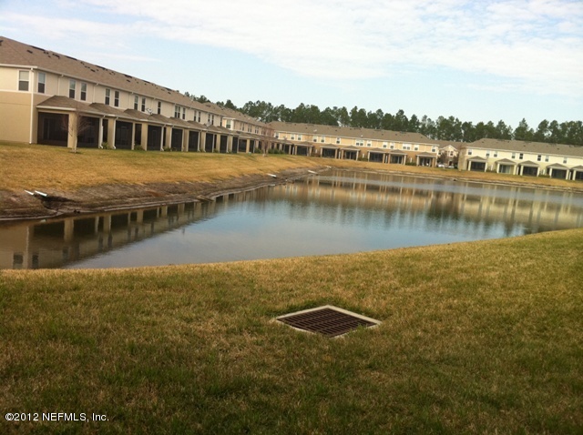 12988 Spring Rain Road Jacksonville, FL 32258 - Photo 10 of 10 a view of a lake with houses in front of it