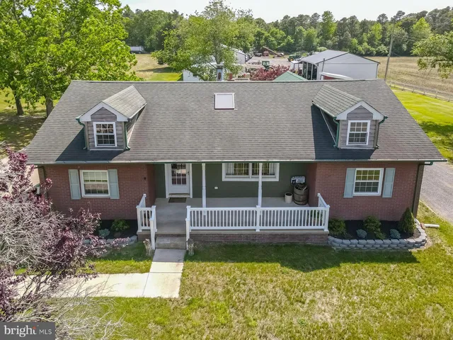 a aerial view of a house with swimming pool next to a yard