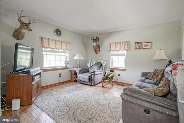 a view of a porch with furniture and a yard