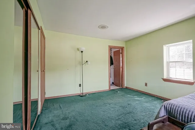 an aerial view of a house with a yard and greenery