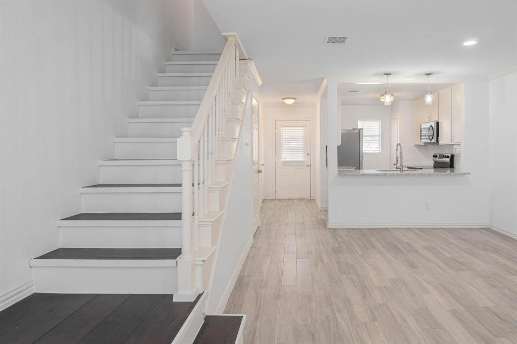 20 Abbey Road Euless, TX 76039 - Photo 7 of 8 Stairway with wood finished floors and baseboards