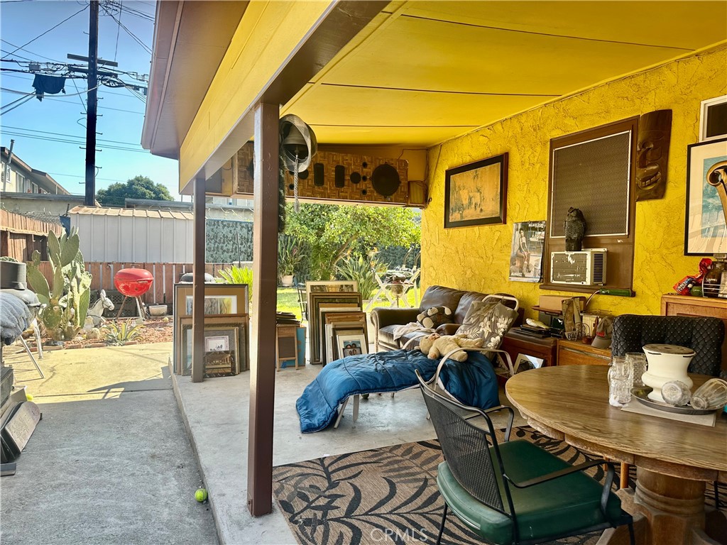 1106 South Washington Avenue Compton, CA 90221 - Photo 2 of 9 a living room with furniture and a floor to ceiling window