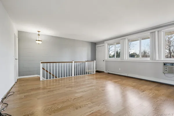 a view of a room with wooden floor