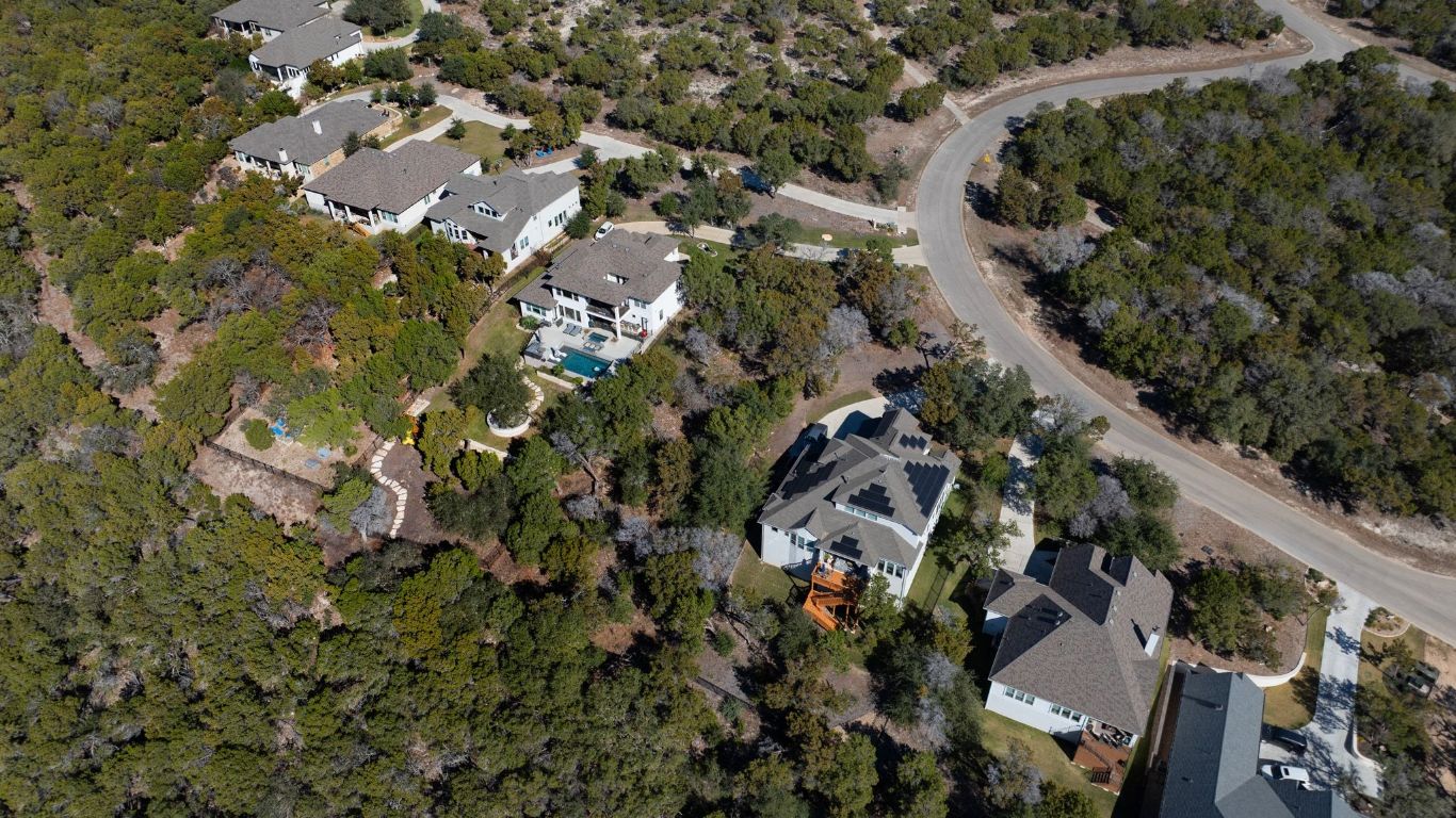 6909 Sunset Ridge Way Jonestown, TX 78645 - Photo 11 of 40 an aerial view of residential houses with outdoor space