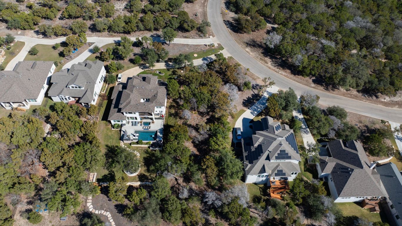 6909 Sunset Ridge Way Jonestown, TX 78645 - Photo 10 of 40 an aerial view of residential houses with outdoor space