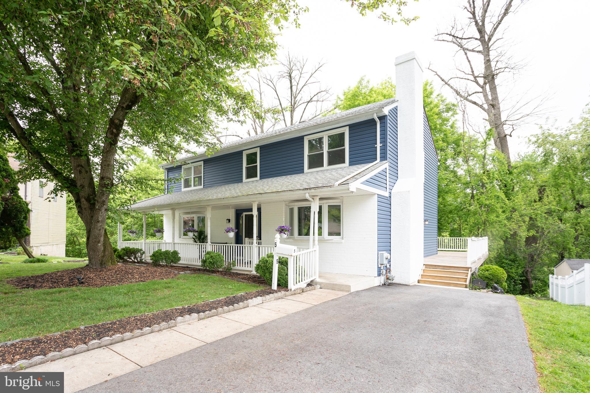 5 Lisa Circle Drexel Hill, PA 19026 - Photo 1 of 41 a front view of a house with a garden and trees