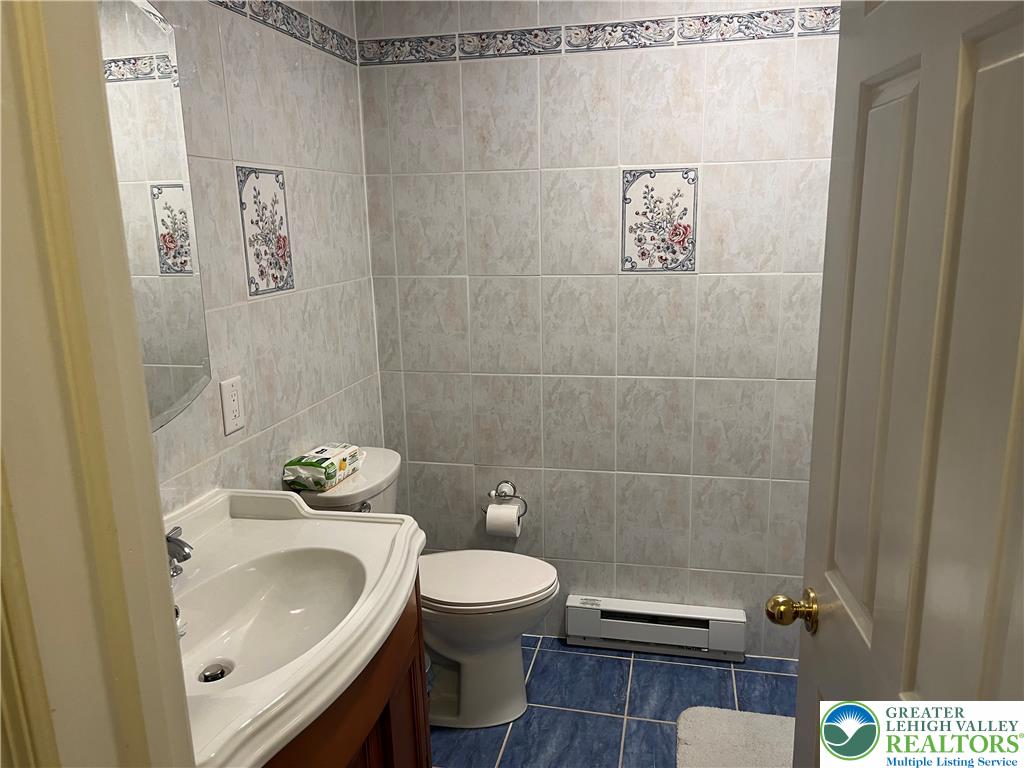 6221 Dove Drive Bethlehem, PA 18017 - Photo 23 of 38 Ornate wall tiling and colorful floor tiles define this functional bathroom space.