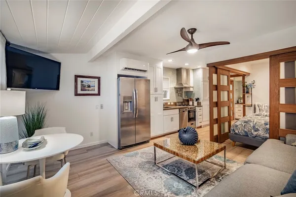 a living room with furniture and a floor to ceiling window