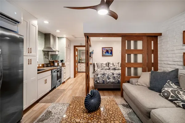 a living room with furniture fireplace and a window