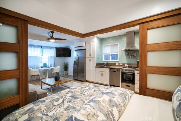 a kitchen with stainless steel appliances kitchen island granite countertop a refrigerator and a stove top oven