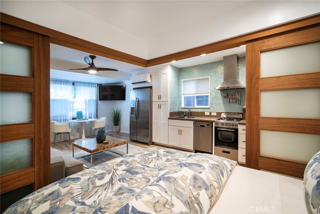 33921 Robles Drive, Unit C Dana Point, CA 92629 - Photo 7 of 17 a kitchen with stainless steel appliances kitchen island granite countertop a refrigerator and a stove top oven