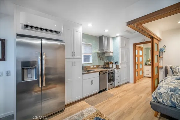 a kitchen with granite countertop a refrigerator and a sink
