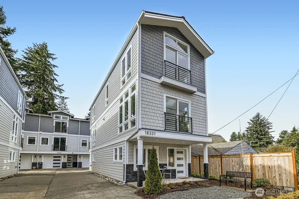 a front view of a residential apartment building with a yard