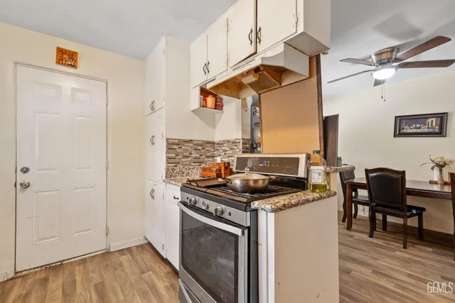 a kitchen with stainless steel appliances granite countertop a stove and a refrigerator