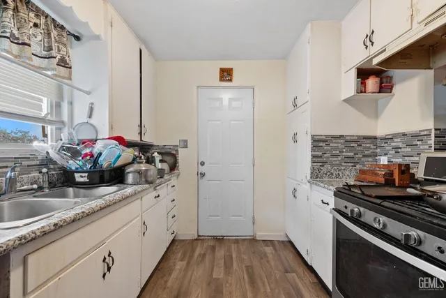 a kitchen with sink stove and cabinets