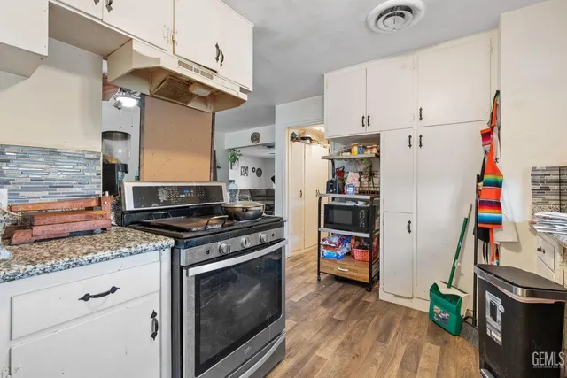 a kitchen with stainless steel appliances granite countertop a stove and a refrigerator