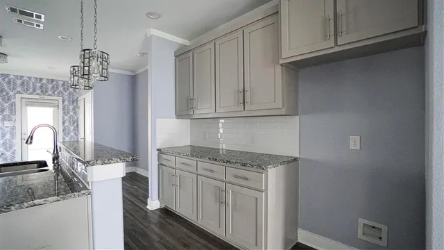 a kitchen with stainless steel appliances granite countertop a sink stove and cabinets