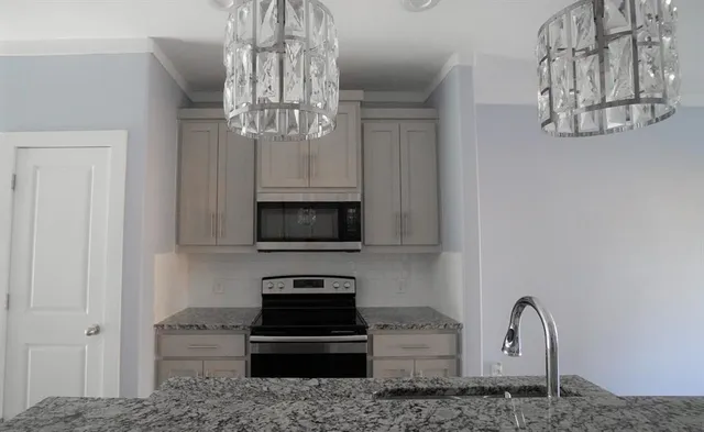 a living room with fireplace furniture and a chandelier