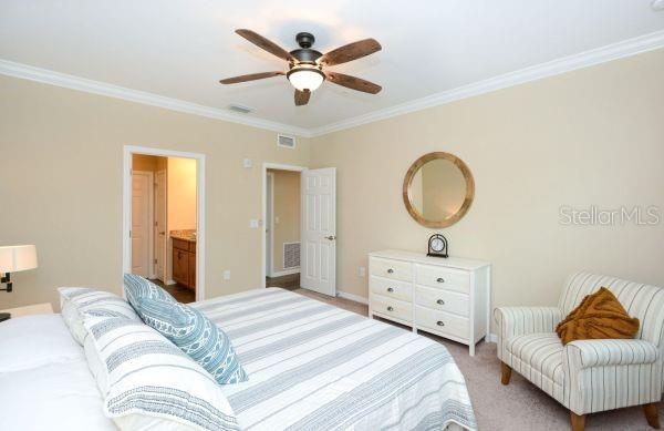 4212 Expedition Way Osprey, FL 34229 - Photo 16 of 28 a bedroom with a bed and a dresser
