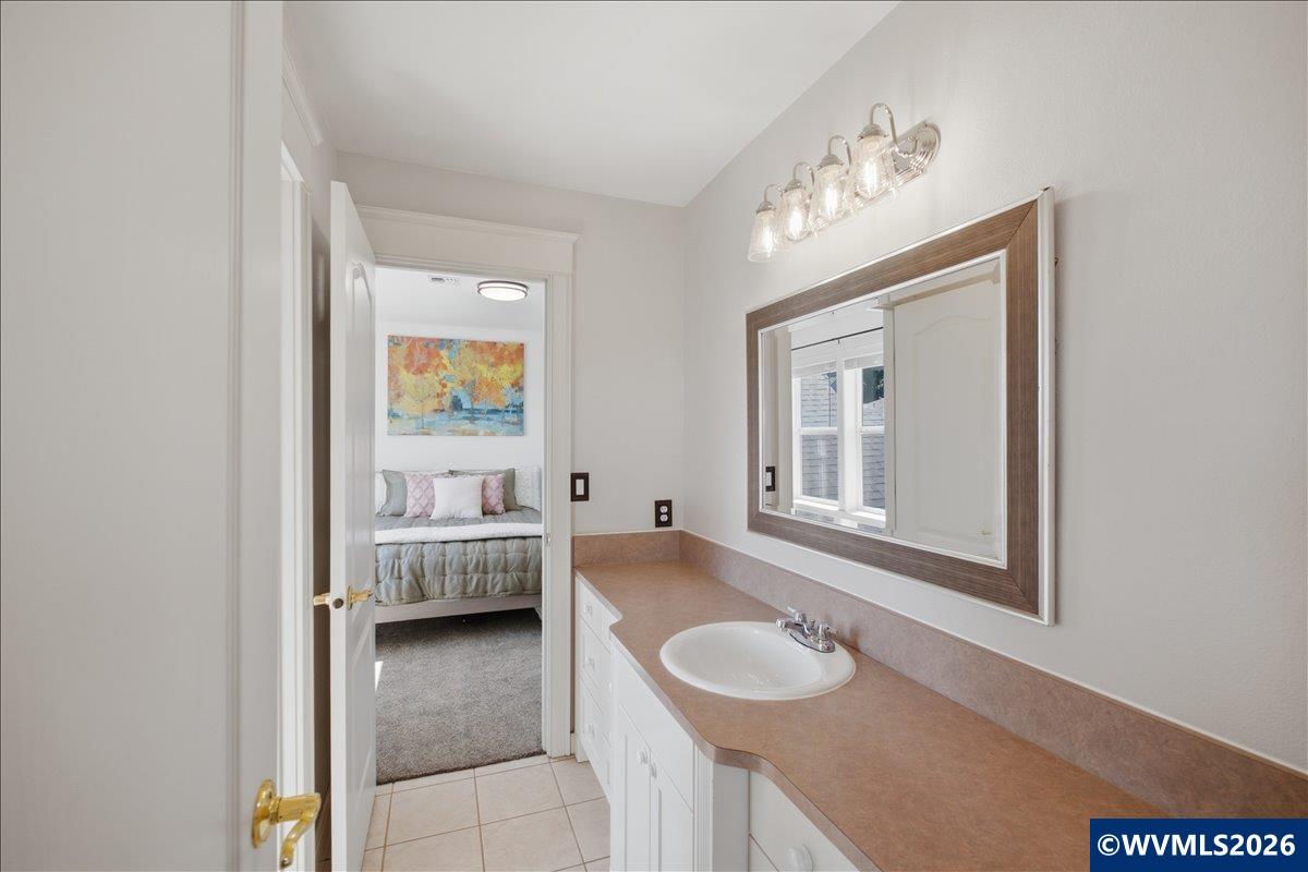 1492 Northwest Penny Lane Albany, OR 97321 - Photo 37 of 50 a en suite bathroom with a granite countertop tub and a large mirror