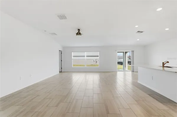 a view of a livingroom with wooden floor and a window