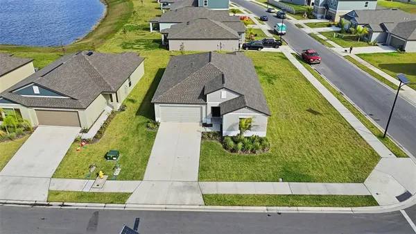 an aerial view of a house with a garden and swimming pool