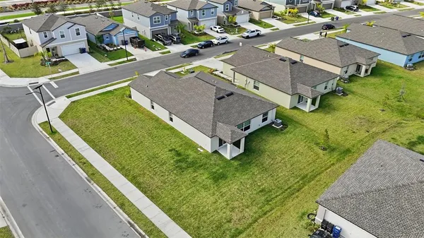 an aerial view of a house with a garden and swimming pool