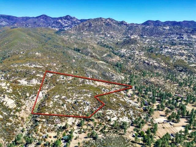 a view of mountains in middle of a field