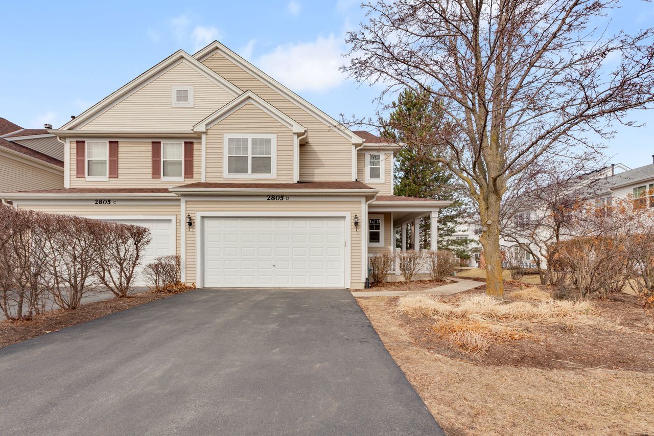 2805 Cattail Court, Unit D Wauconda, IL 60084 - Photo 1 of 30 a front view of a house with a yard and garage