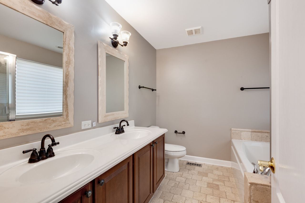 2805 Cattail Court, Unit D Wauconda, IL 60084 - Photo 15 of 30 a bathroom with a sink and a mirror