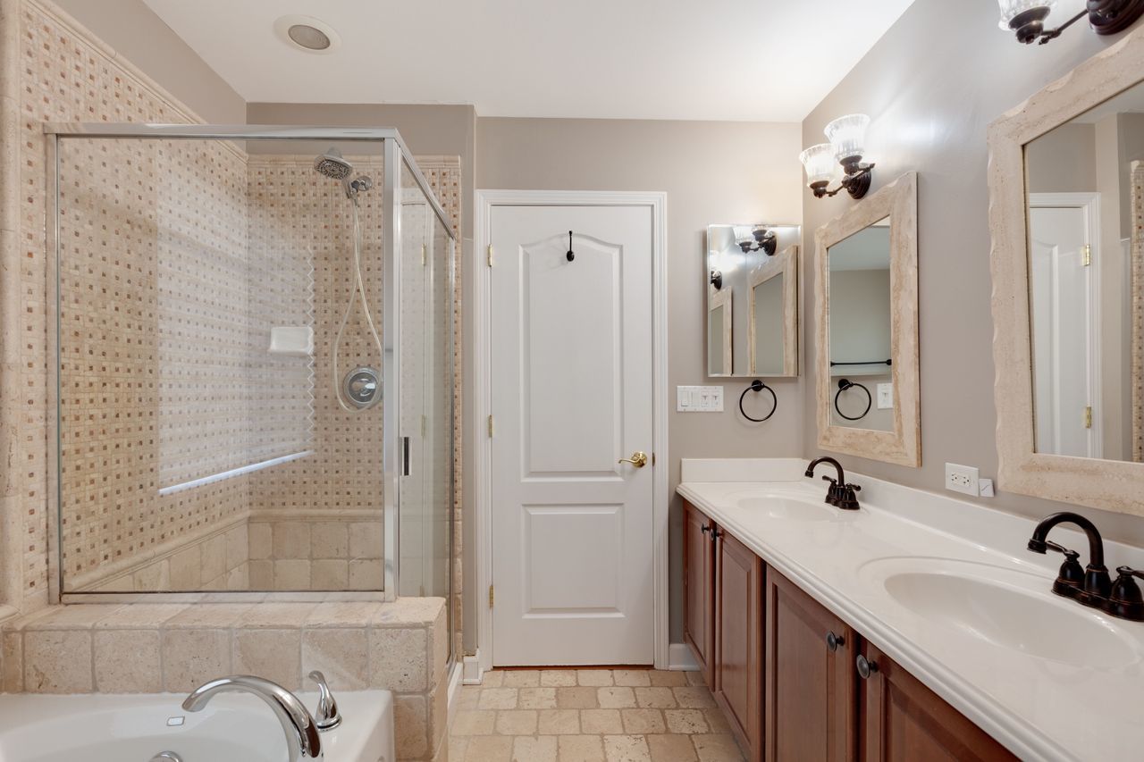 2805 Cattail Court, Unit D Wauconda, IL 60084 - Photo 16 of 30 a bathroom with a double vanity sink mirror and shower