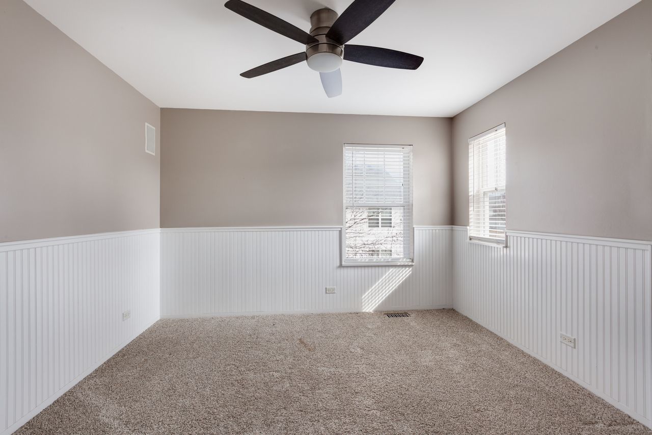 2805 Cattail Court, Unit D Wauconda, IL 60084 - Photo 18 of 30 an empty room with windows and fan