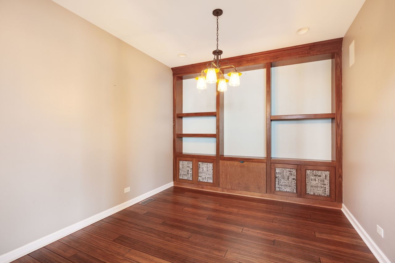 2805 Cattail Court, Unit D Wauconda, IL 60084 - Photo 4 of 30 a view of an empty room with a window and wooden floor