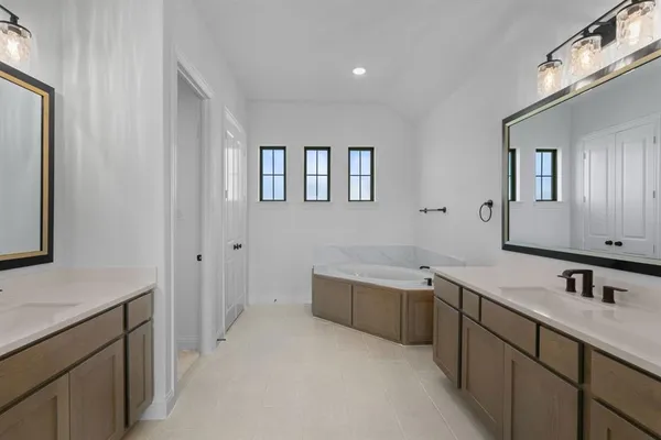 a bathroom with a double vanity sink and mirror