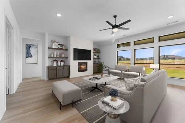 a living room with fireplace furniture and a large window