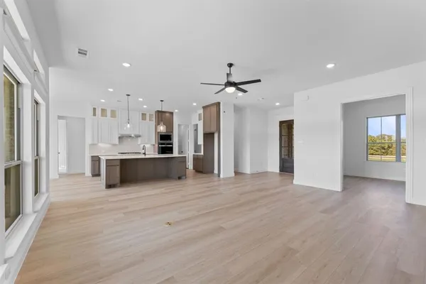 a view of a kitchen with a sink and a refrigerator