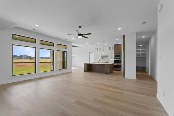 a view of a kitchen with a sink and a large window