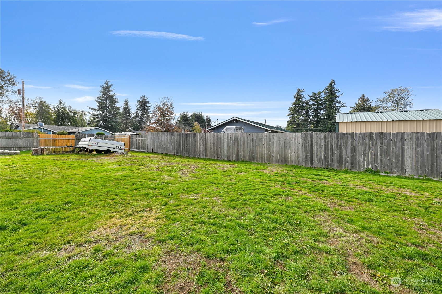 1474 Crestview Road Ferndale, WA 98248 - Photo 29 of 30 a view of a backyard with a garden and fire pit
