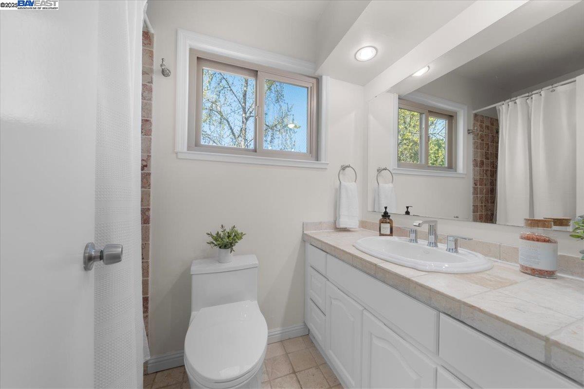 427 Chalda Way Moraga, CA 94556 - Photo 13 of 28 A tasteful toilet room featuring a shower-over-tub combo—for spa-like soaks in comfort and style.