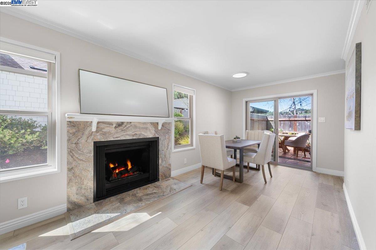 427 Chalda Way Moraga, CA 94556 - Photo 26 of 28 Idyllic open floor plan that seamlessly connects the living room to the dining room. Per AB 723 - Fire in fireplace has been digitally rendered.