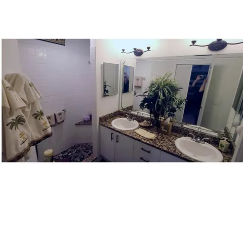 a bathroom with sink a mirror and vanity